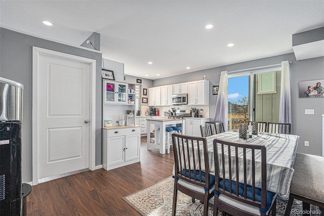 dining area with dark hardwood / wood-style flooring