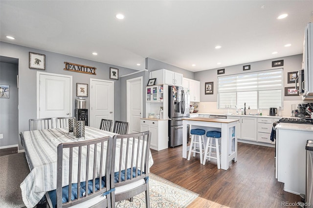 dining space with dark hardwood / wood-style floors and sink