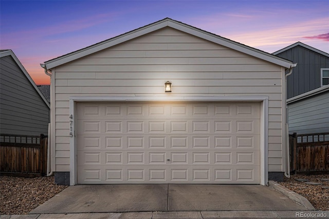 view of garage at dusk