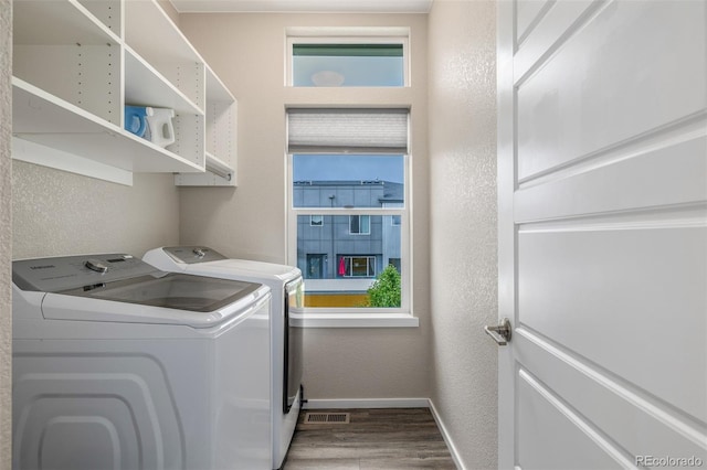 1754 W 66th Ave, Denver, CO 80221 - laundry area featuring washing machine and dryer, wood finished floors, baseboards, a textured wall, and healthy amount of natural light