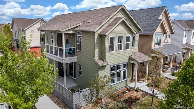 1754 W 66th Ave, Denver, CO 80221 - back of house featuring a residential view, a shingled roof, and a balcony