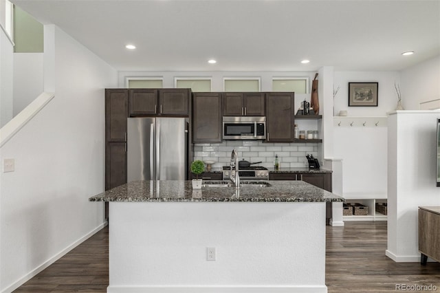 1754 W 66th Ave, Denver, CO 80221 - kitchen featuring stainless steel appliances, dark brown cabinets, a sink, dark stone countertops, and recessed lighting