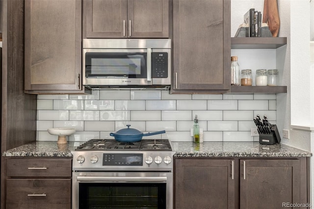 1754 W 66th Ave, Denver, CO 80221 - kitchen featuring appliances with stainless steel finishes, decorative backsplash, dark brown cabinets, dark stone countertops, and open shelves