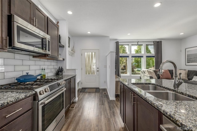 1754 W 66th Ave, Denver, CO 80221 - kitchen with stainless steel appliances, a sink, dark stone counters, and recessed lighting
