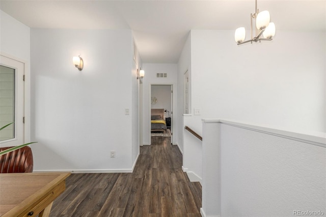 1754 W 66th Ave, Denver, CO 80221 - corridor featuring wood finished floors, baseboards, and a chandelier
