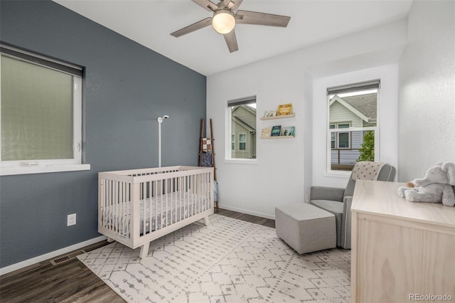 1754 W 66th Ave, Denver, CO 80221 - bedroom featuring light wood-style floors, a crib, baseboards, and ceiling fan