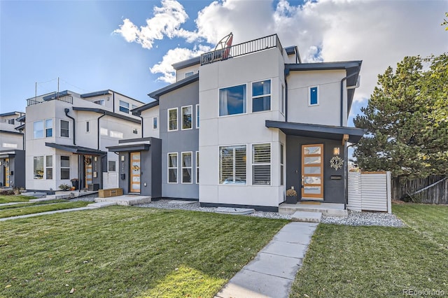 contemporary home featuring a front lawn