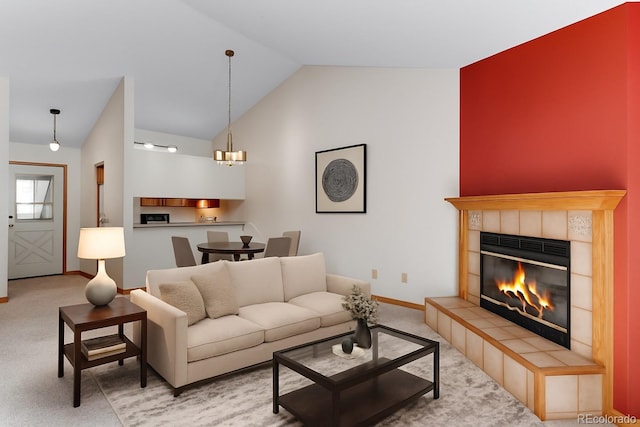 2960 W Stuart St Unit 302, Fort Collins, CO 80526 - carpeted living room with lofted ceiling, a tiled fireplace, and a chandelier