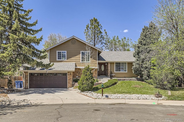 1973 S Pitkin St, Aurora, CO 80013 - split level home featuring stone siding, driveway, a garage, and roof with shingles