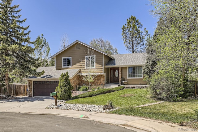 1973 S Pitkin St, Aurora, CO 80013 - tri-level home with a shingled roof, driveway, and a garage