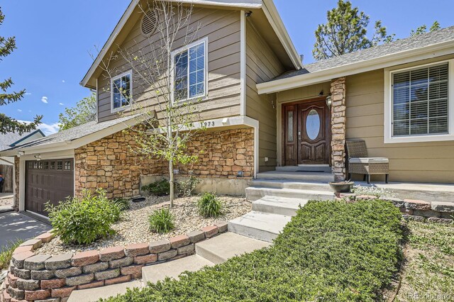 1973 S Pitkin St, Aurora, CO 80013 - property entrance featuring stone siding and roof with shingles