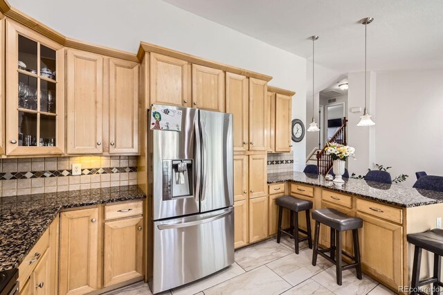 1973 S Pitkin St, Aurora, CO 80013 - kitchen featuring stainless steel refrigerator with ice dispenser, a peninsula, light brown cabinets, glass insert cabinets, and decorative backsplash