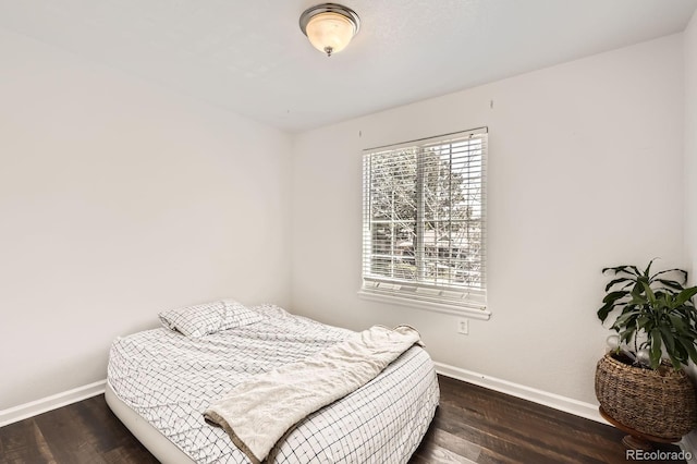 1973 S Pitkin St, Aurora, CO 80013 - bedroom featuring baseboards and wood finished floors