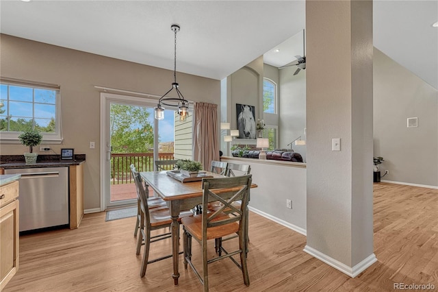 dining room featuring baseboards, light wood finished floors, and a wealth of natural light