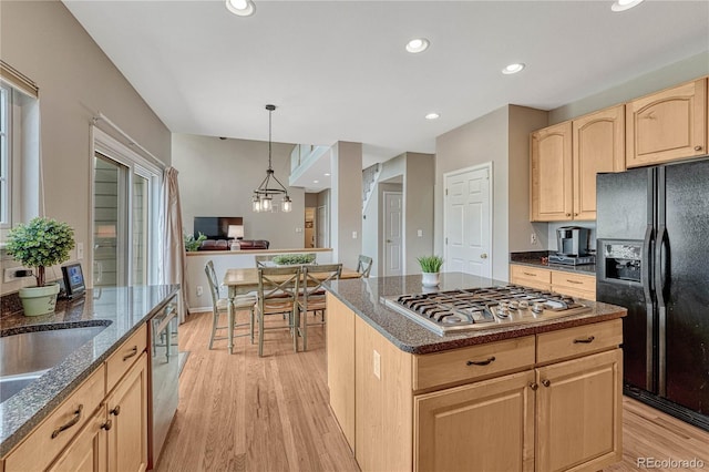 kitchen with light wood-type flooring, dark stone countertops, light brown cabinets, stainless steel appliances, and recessed lighting