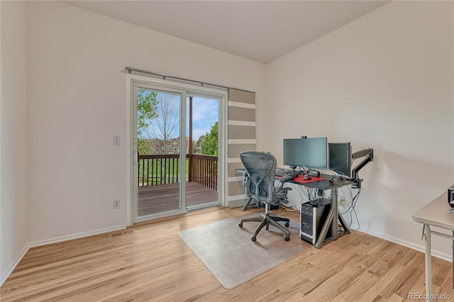 office with baseboards and wood finished floors