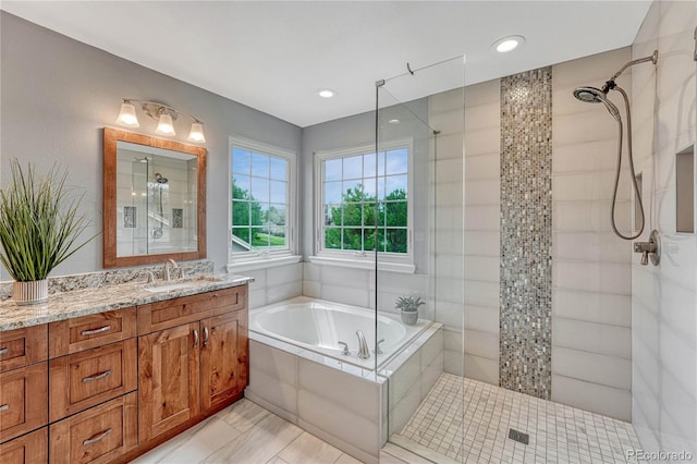 bathroom featuring vanity, recessed lighting, walk in shower, and a bath