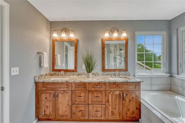 full bath featuring double vanity, walk in shower, a sink, and a garden tub