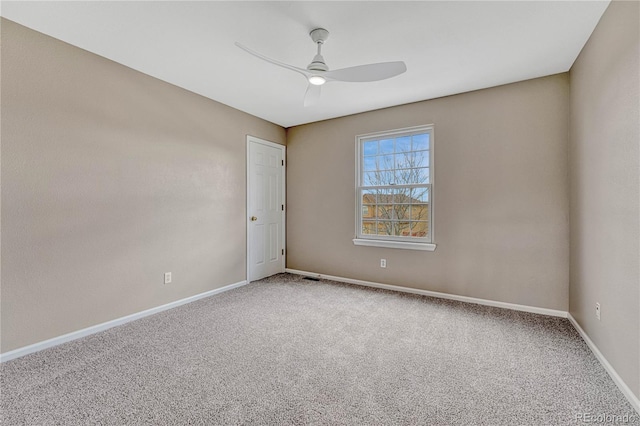 empty room featuring carpet floors, baseboards, ceiling fan, and visible vents