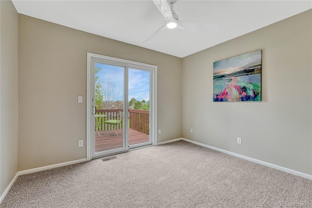 unfurnished room with carpet floors, baseboards, and a ceiling fan