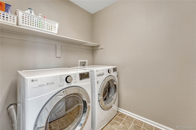 laundry area featuring laundry area, baseboards, and separate washer and dryer