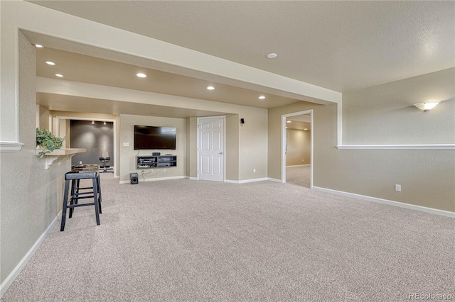 unfurnished living room featuring baseboards, light carpet, and recessed lighting