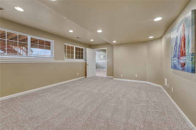 unfurnished room with carpet floors, recessed lighting, baseboards, and visible vents