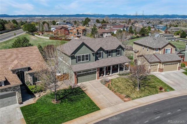 drone / aerial view with a residential view and a mountain view