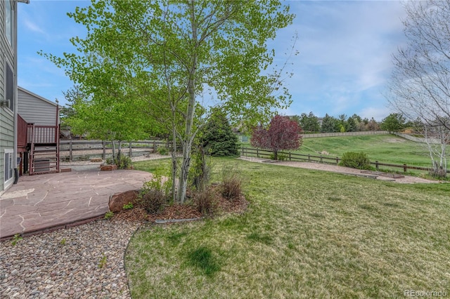 view of yard with a fenced backyard, a patio area, and a deck