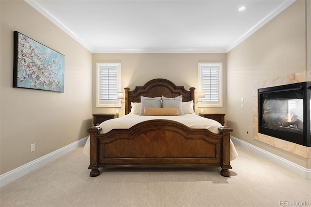 bedroom featuring baseboards, light carpet, a fireplace, and crown molding