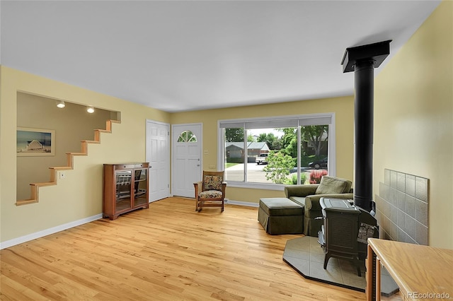 5047 S Mabre Ct, Littleton, CO 80123 - living area with a wood stove, light wood-type flooring, and stairway