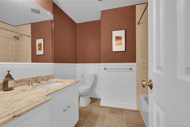 5047 S Mabre Ct, Littleton, CO 80123 - bathroom featuring vanity, tile patterned floors, bathing tub / shower combination, and a wainscoted wall