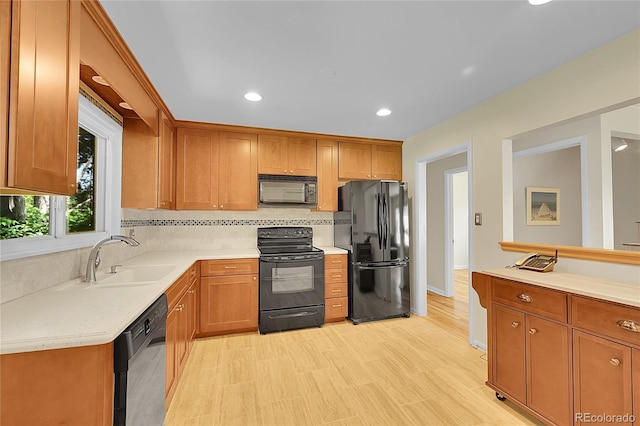 5047 S Mabre Ct, Littleton, CO 80123 - kitchen featuring black appliances, tasteful backsplash, light countertops, recessed lighting, and brown cabinets