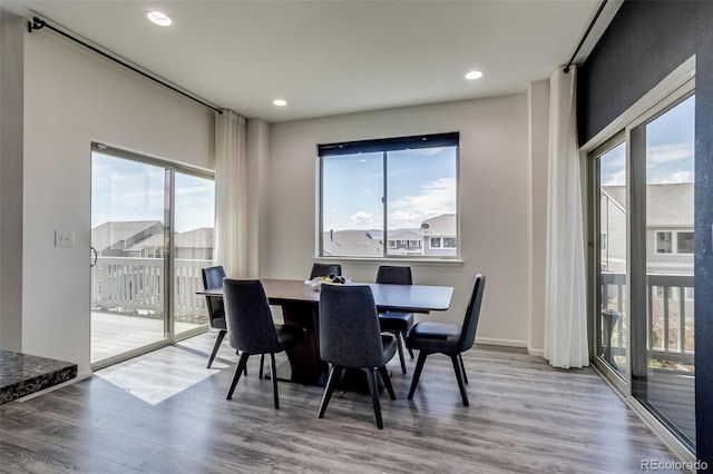 dining room with plenty of natural light, wood finished floors, and recessed lighting
