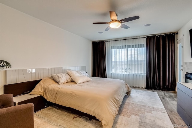 bedroom with light wood-style flooring and ceiling fan