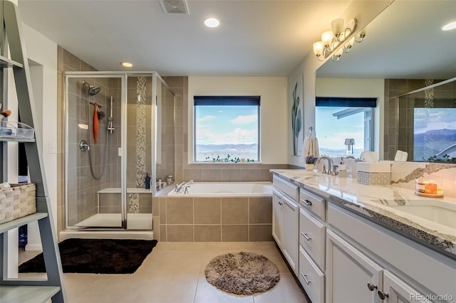 bathroom with a shower stall, a bath, double vanity, tile patterned floors, and recessed lighting
