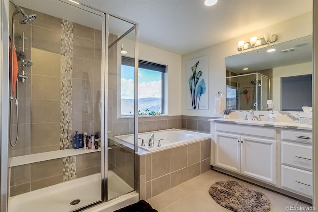 full bathroom featuring a stall shower, a bath, vanity, and tile patterned floors