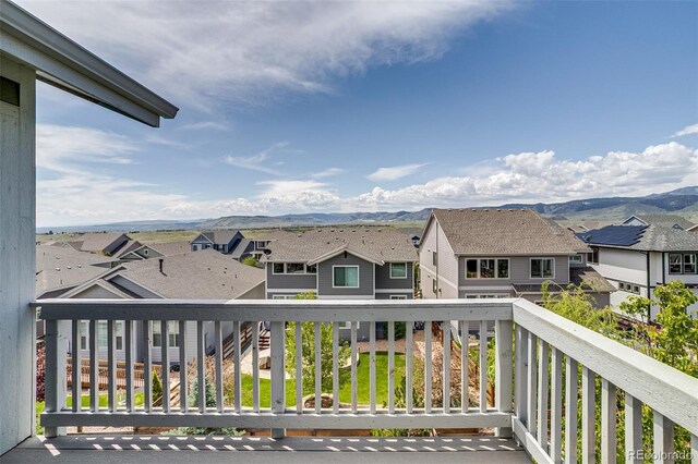 balcony with a residential view and a mountain view