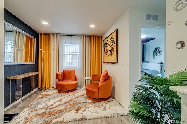 living area featuring wood finished floors, a fireplace, baseboards, and recessed lighting