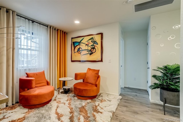 sitting room featuring wood finished floors, recessed lighting, and baseboards