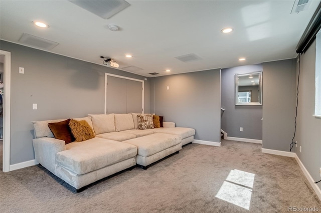 carpeted living area featuring recessed lighting and baseboards