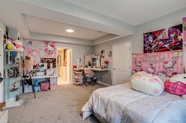 bedroom with carpet floors, a tray ceiling, a desk, ensuite bathroom, and recessed lighting
