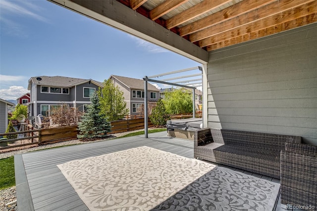 view of patio / terrace with a covered hot tub, a residential view, and fence