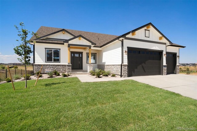 craftsman-style home featuring a garage and a front lawn