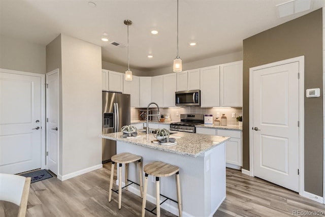 6807 Huddersfield Ln, Castle Pines, CO 80108 - kitchen featuring visible vents, appliances with stainless steel finishes, and light wood-type flooring
