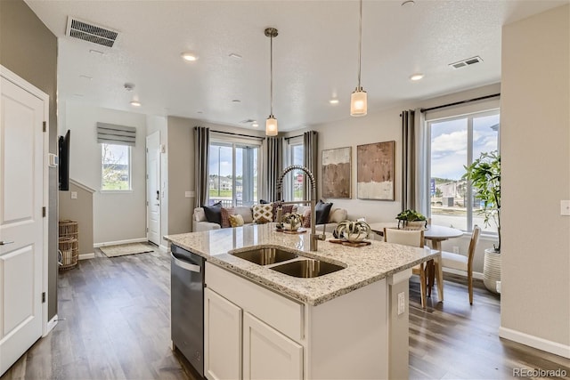 6807 Huddersfield Ln, Castle Pines, CO 80108 - kitchen with visible vents, dark wood-style floors, a sink, and dishwasher
