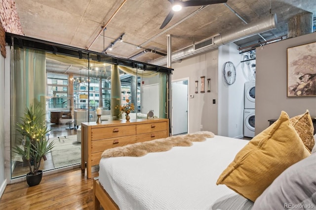 1720 Wazee St Unit 2B, Denver, CO 80202 - bedroom with stacked washer and clothes dryer and wood finished floors