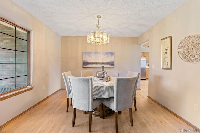 9447 Chesapeake St, Highlands Ranch, CO 80126 - dining space featuring a chandelier, light wood-style floors, and a textured ceiling