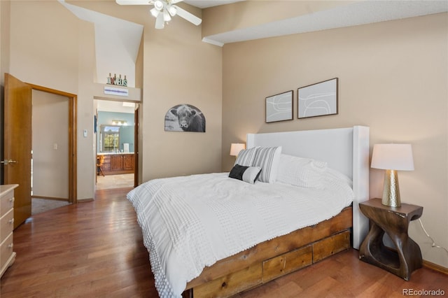 9447 Chesapeake St, Highlands Ranch, CO 80126 - bedroom featuring wood finished floors, a towering ceiling, and ensuite bath