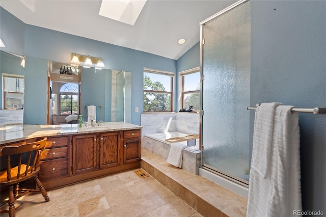 9447 Chesapeake St, Highlands Ranch, CO 80126 - bathroom with lofted ceiling, a skylight, vanity, a bath, and a stall shower